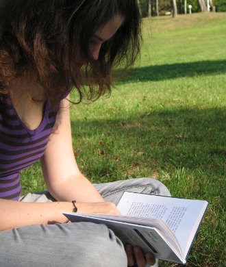 girl reading a book outside